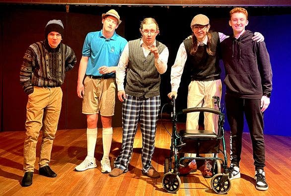 5 male students dressed in plain clothing for drama performance