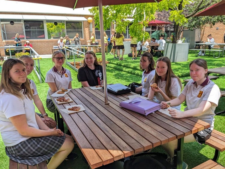 A group of girls sitting at a table