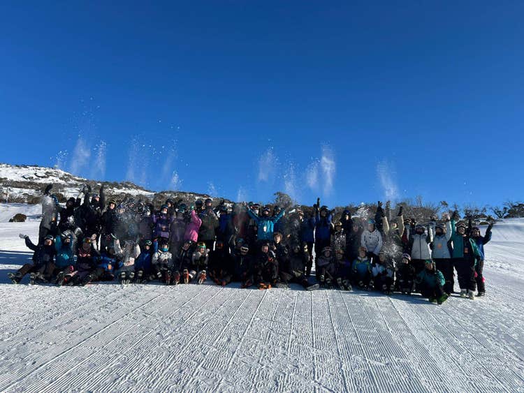 A group of people standing in the snow