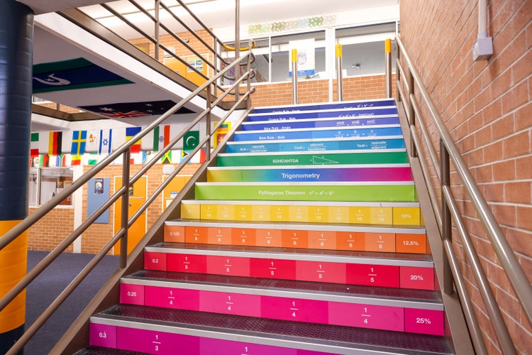 A multicoloured staircase with metal handrails