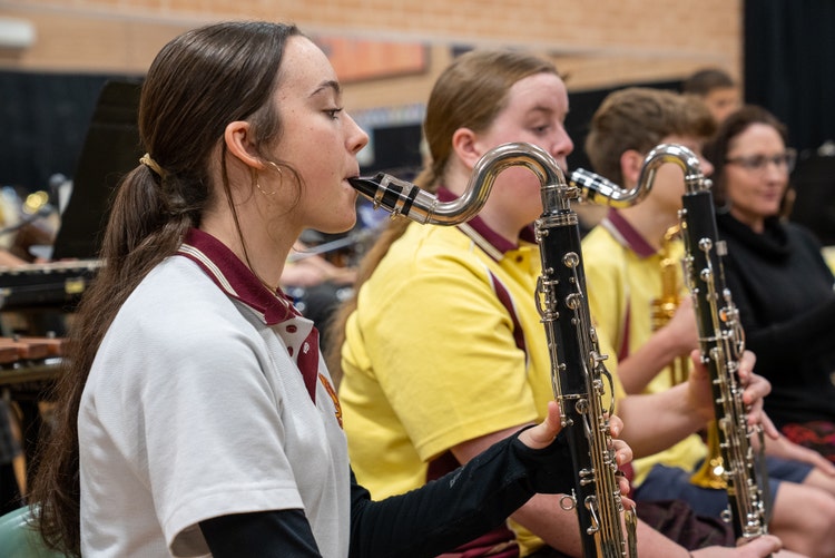 Female students playing bass clarinets