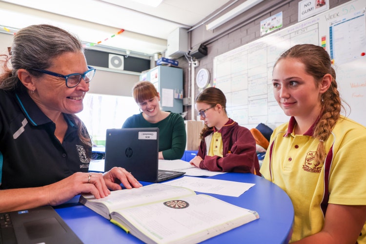 Two teachers and two students working together in the learning hub