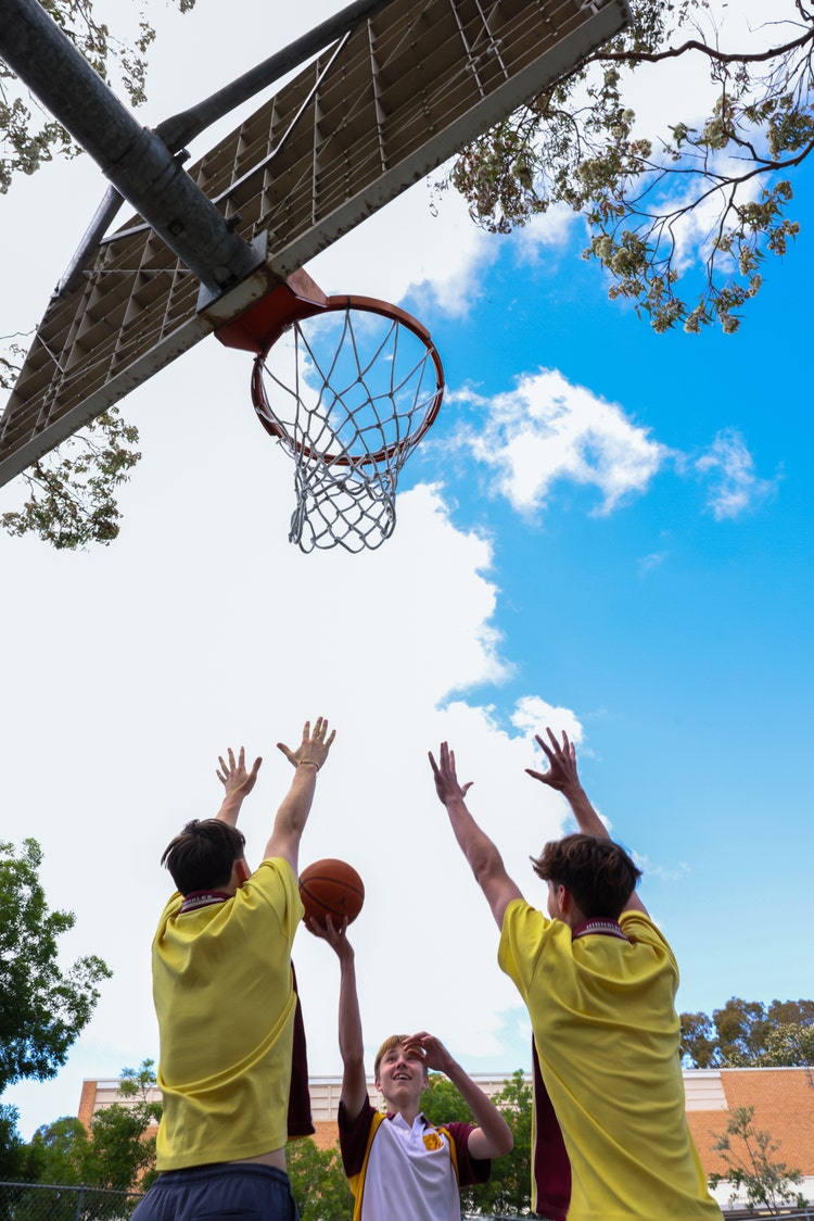 A group of people playing basketball