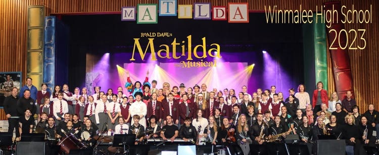 Cast of school musical on stage