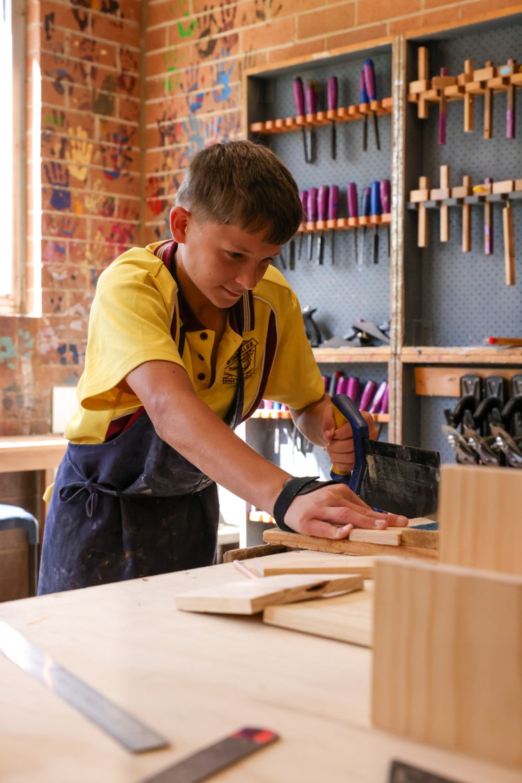 A child working on a piece of wood