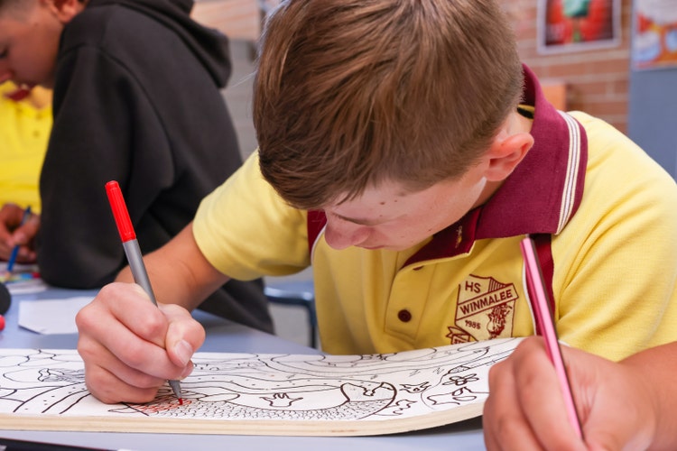 A student writing on a piece of paper
