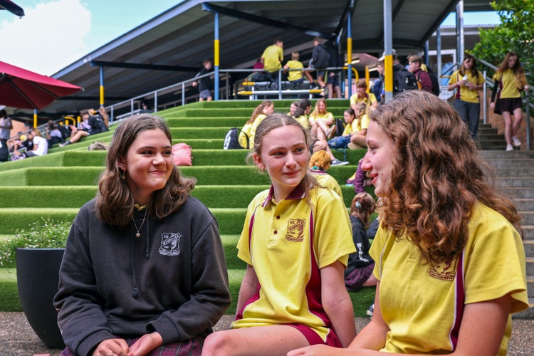 A group of girls sitting on steps