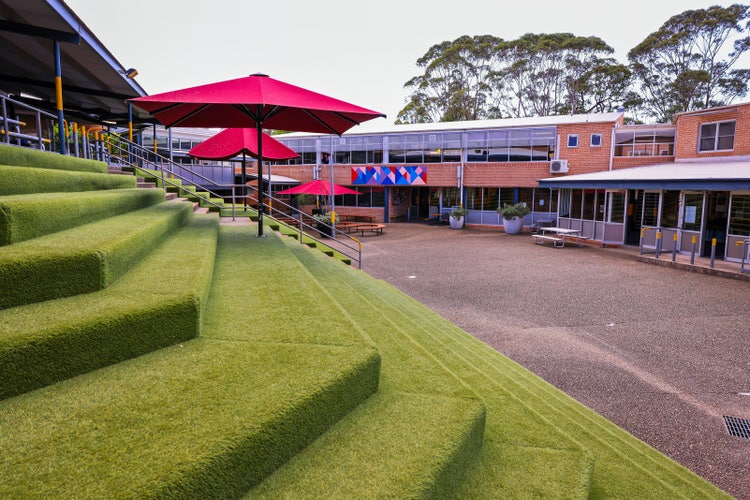 A building with green steps and umbrellas