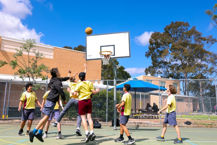 A group of people playing basketball
