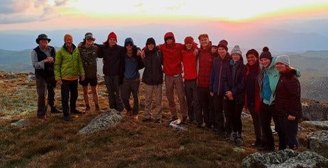 A group of people standing on a mountain