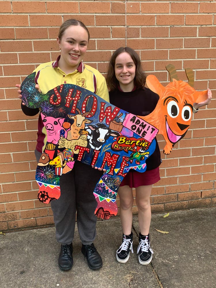 Two people holding up a sign